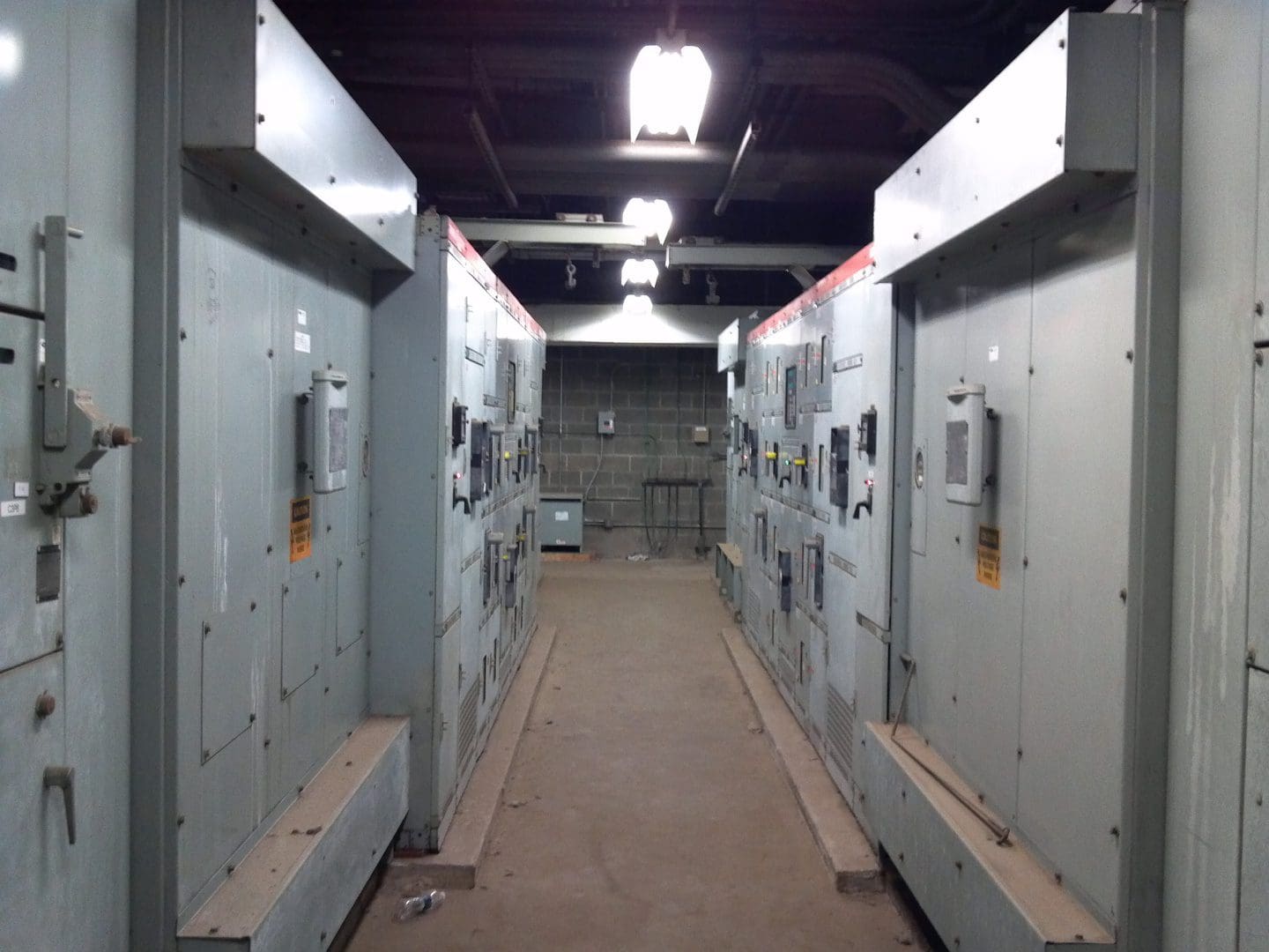 Industrial electrical control panels in a utility corridor.