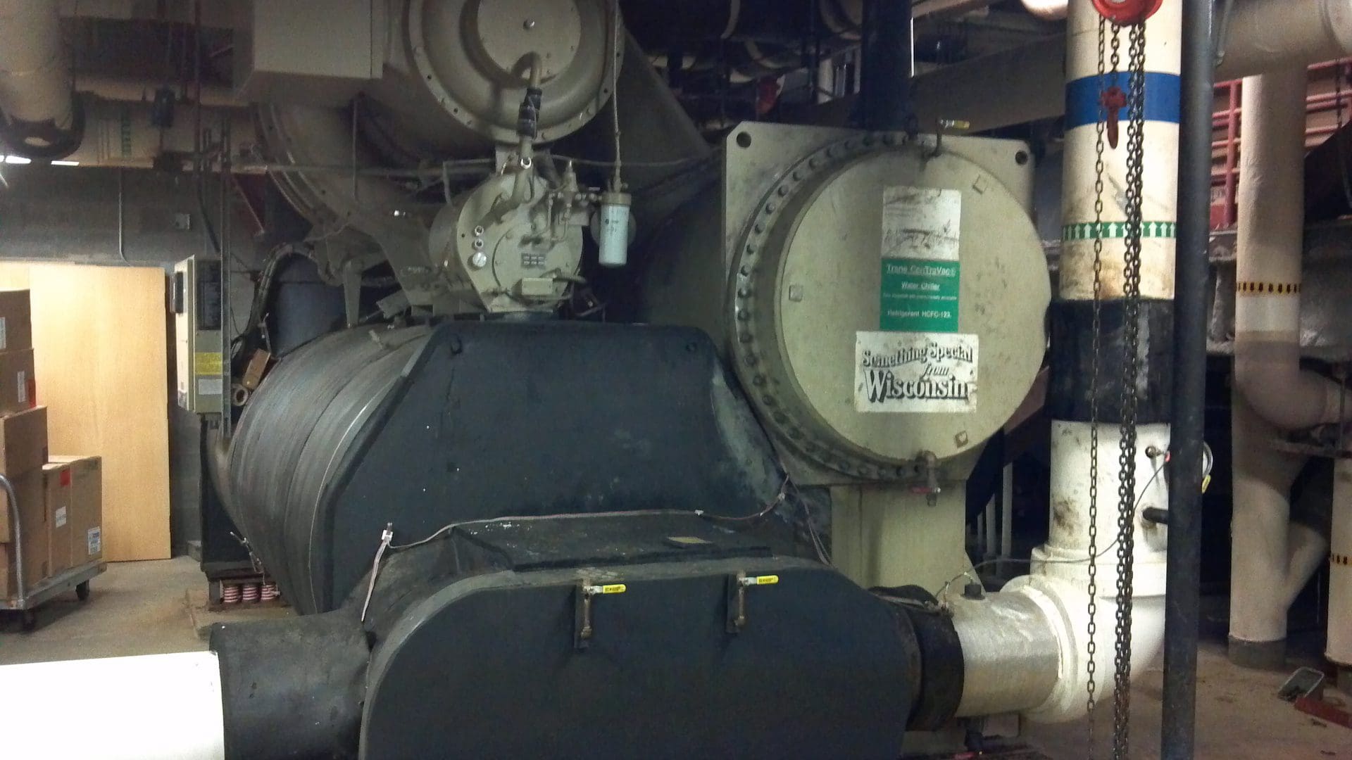 Close-up of industrial machinery with labels and pipes.