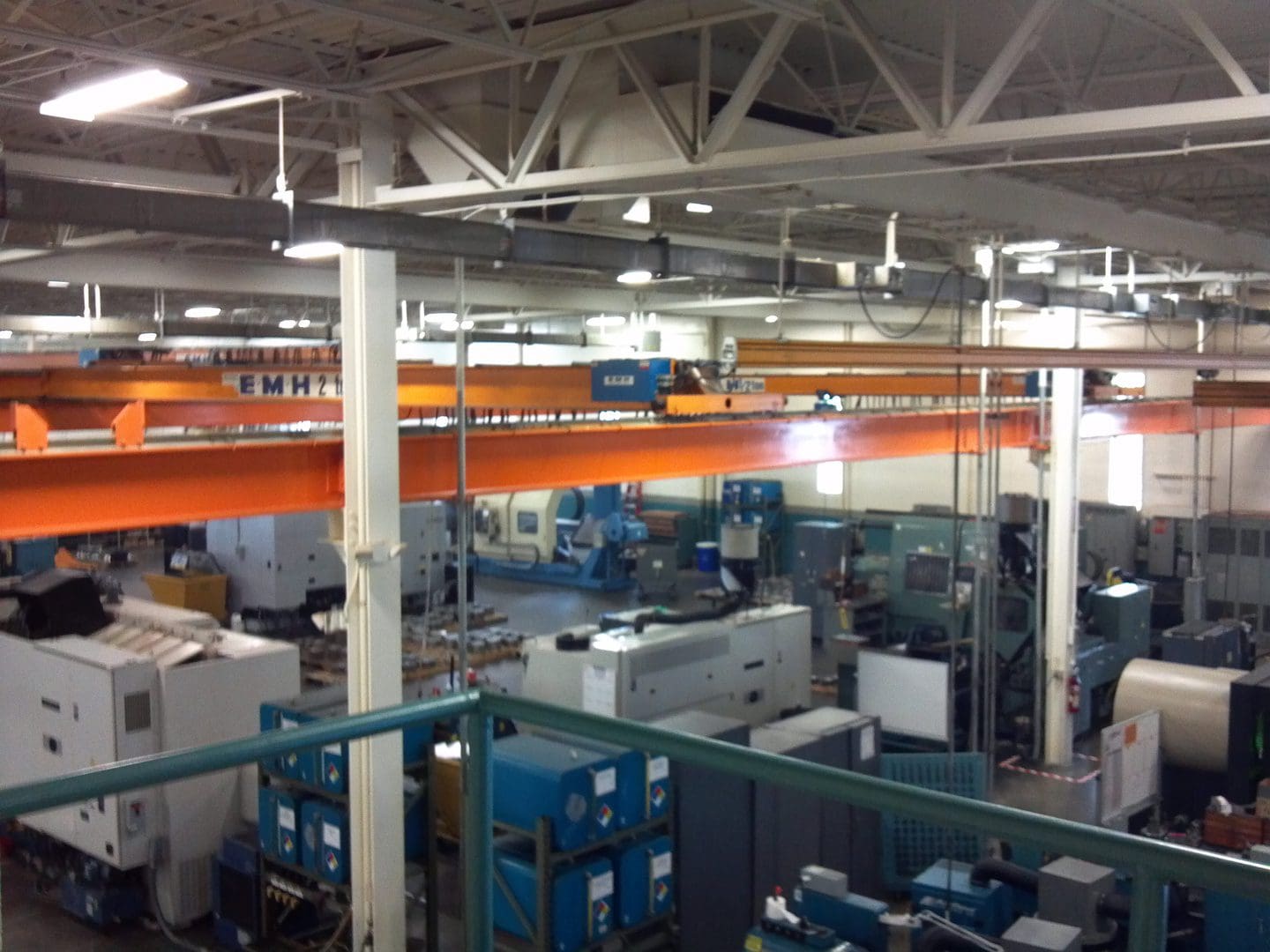 Inside a large industrial factory with machinery and equipment.