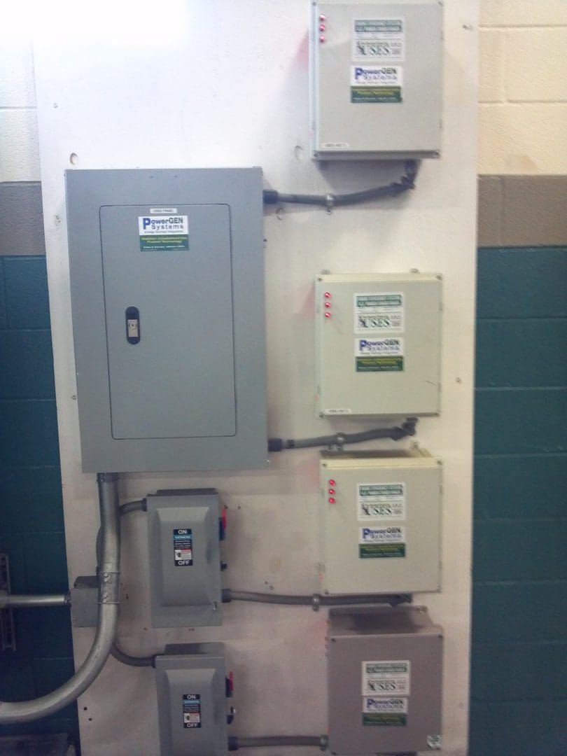 Electrical control panels mounted on a wall in an industrial setting.