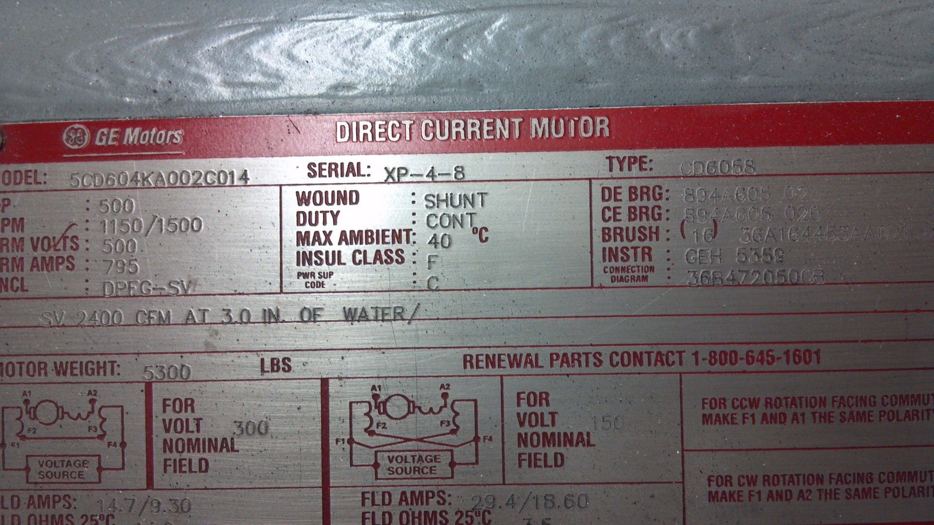 Close-up of a metal machinery nameplate with technical specifications and serial information.